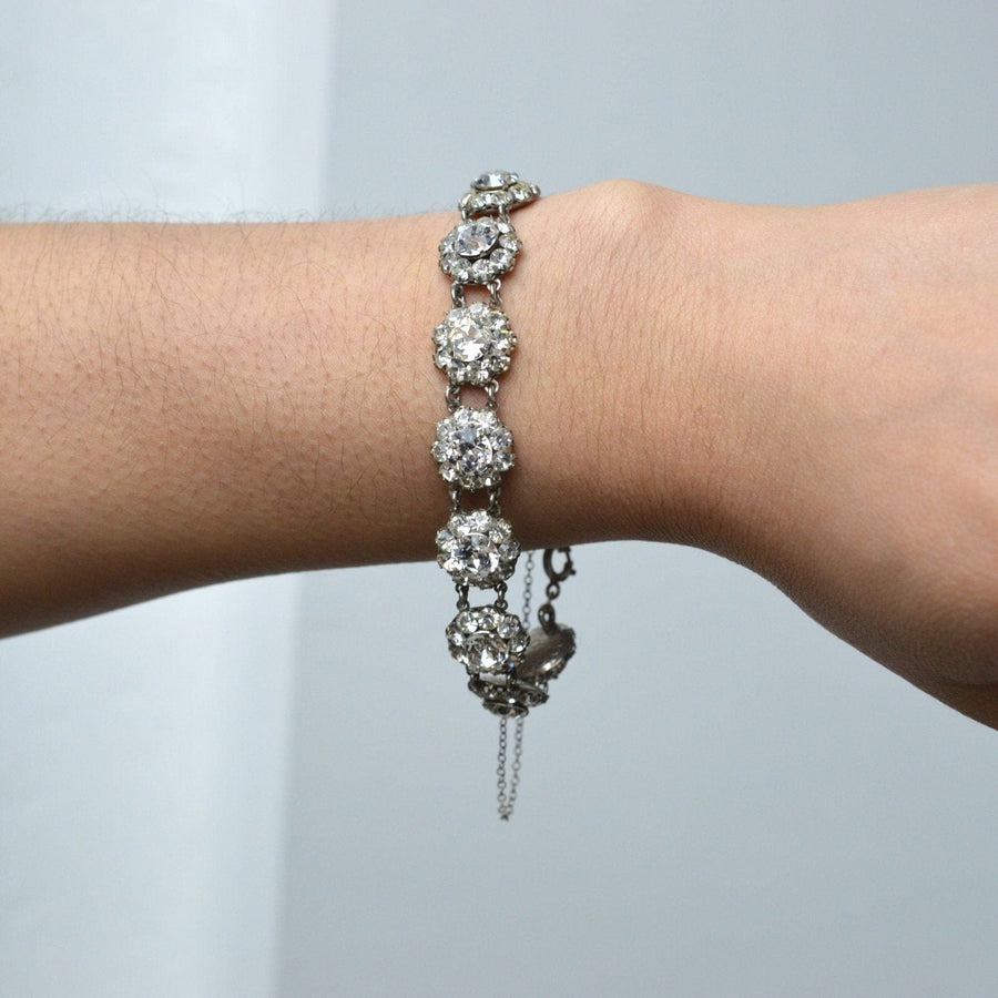 Art Deco silver bracelet featuring twelve diamond paste clusters, elegantly adorned on a wrist.