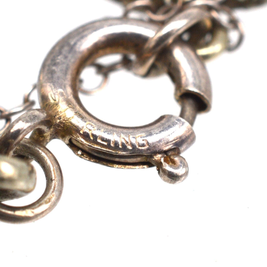 Close-up of the clasp on an Art Deco silver bracelet, showcasing the 'Sterling' engraving.