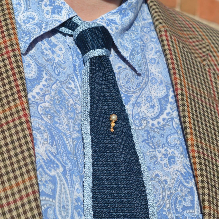 Elegant Art Nouveau 15ct gold pearl tie pin on a stylish navy tie, showcasing timeless vintage appeal.