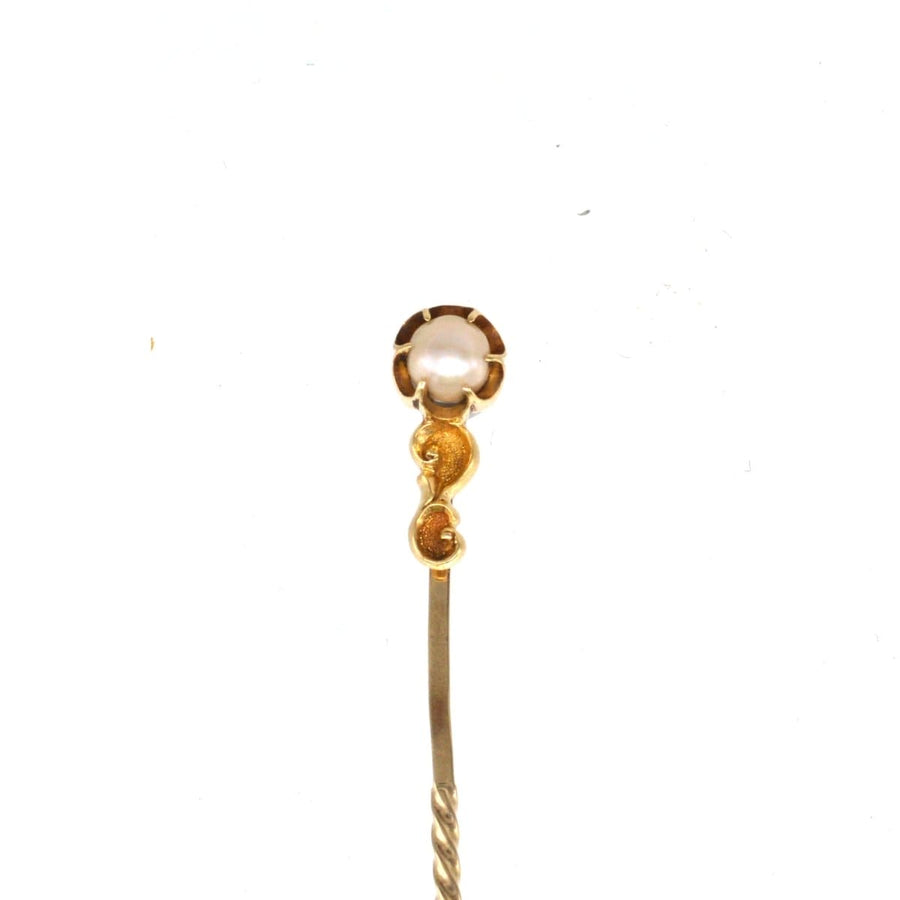Art Nouveau 15ct gold pearl tie pin featuring a lustrous pearl and elegant baroque scroll design.