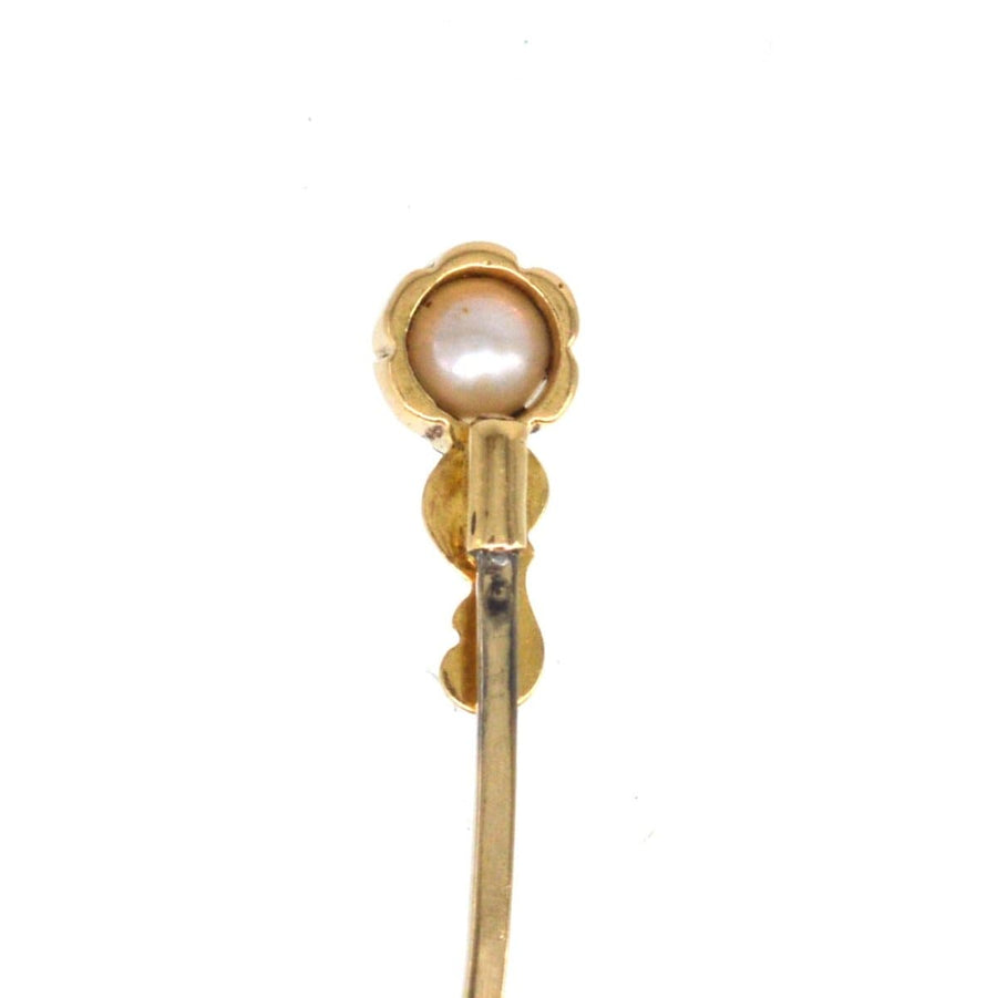 Art Nouveau 15ct gold tie pin featuring a lustrous pearl with elegant scroll detailing, crafted in the 1890s.