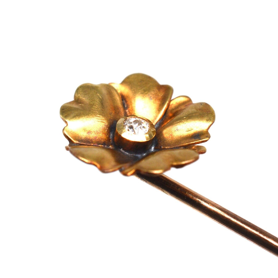 Art Nouveau 9ct gold flower tie pin with a sparkling diamond center, showcasing elegant curves and nature-inspired design.