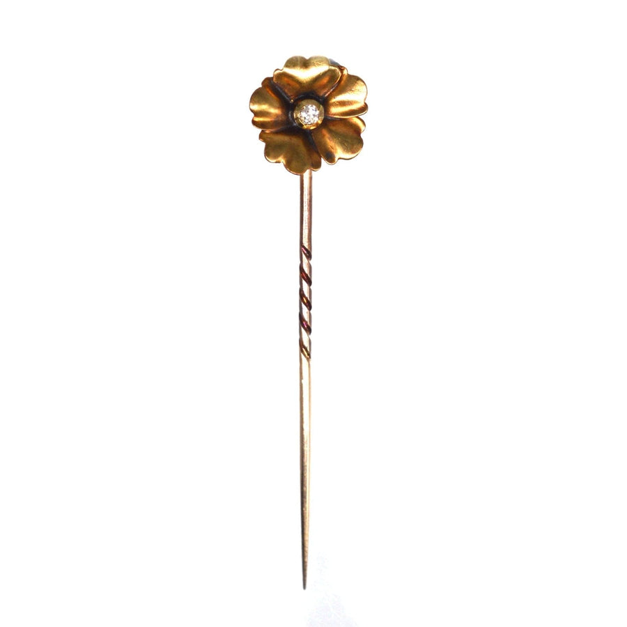 Art Nouveau 9ct gold flower tie pin featuring a diamond, embodying nature-inspired design and elegant curves.