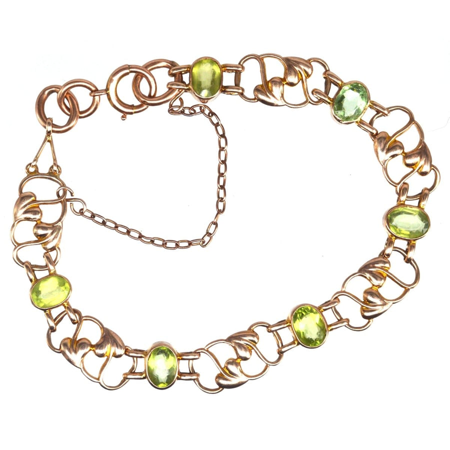 Art Nouveau 9ct gold bracelet featuring six peridots, dating back to the 1910s, with stylized leaf pattern.