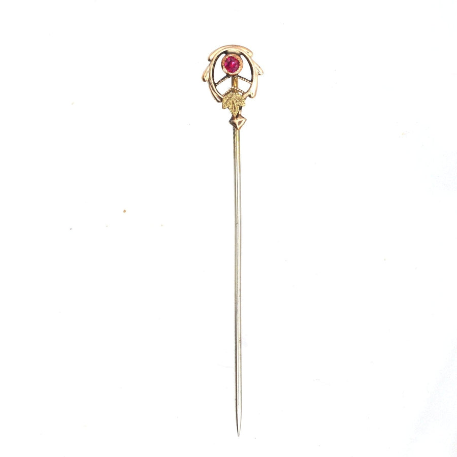 Art Nouveau 9ct two colour gold tie pin featuring stylised gold leaves and a ruby in millegrain setting.