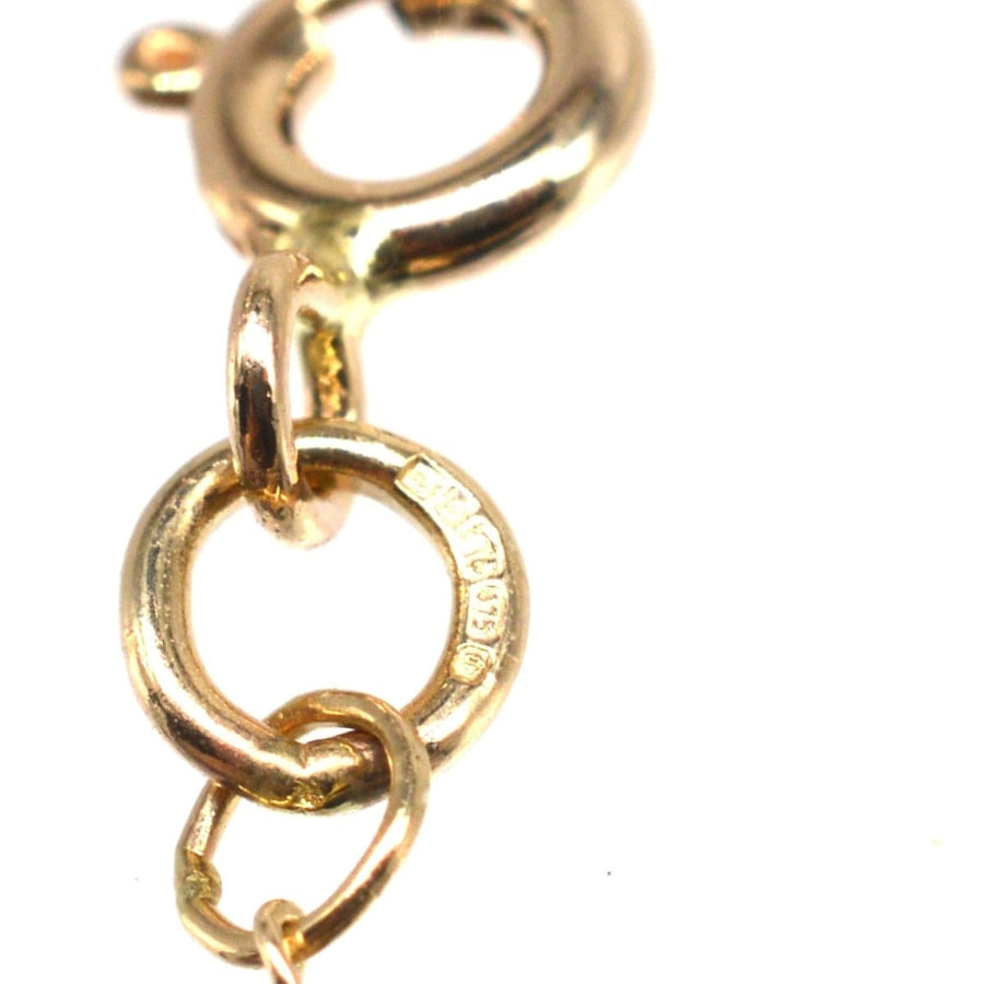 Close-up of contemporary 9ct gold curb chain links showcasing craftsmanship and polish.
