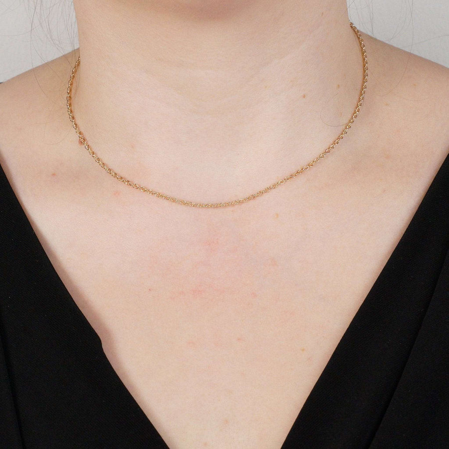 9ct rose gold Prince of Wales rope chain worn on the neck, showcasing its delicate design and polished finish.
