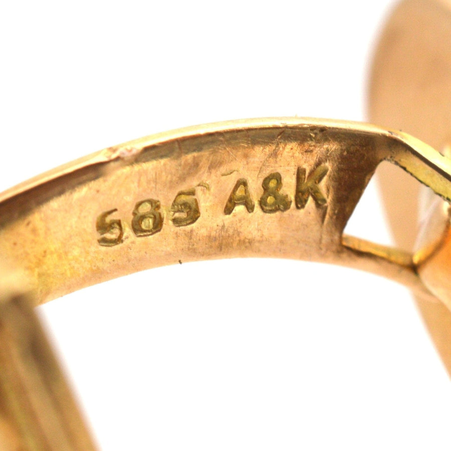 Close-up of the hallmark on Danish 14ct gold cufflinks by Aarre & Krogh, showing 585 and A&K.