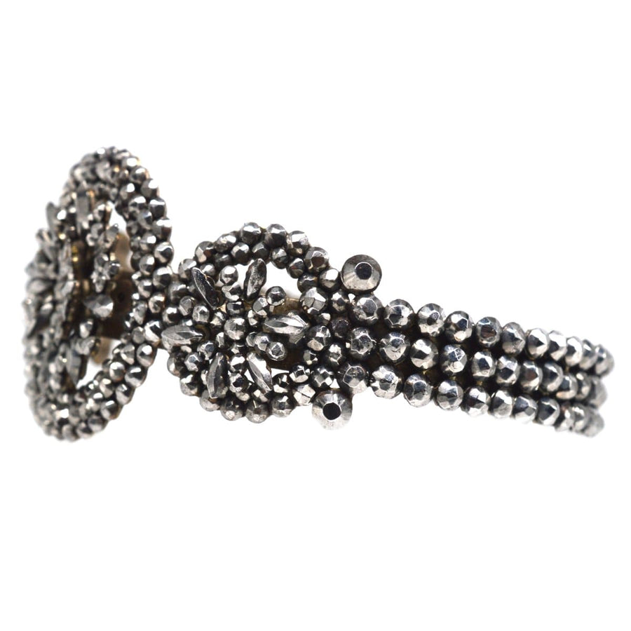 Early 19th century cut steel bangle featuring intricate designs and a shiny polished finish.