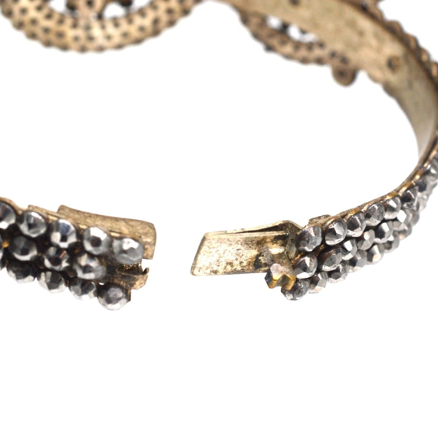 Close-up of an early 19th century cut steel bangle showcasing intricate riveted steel studs.