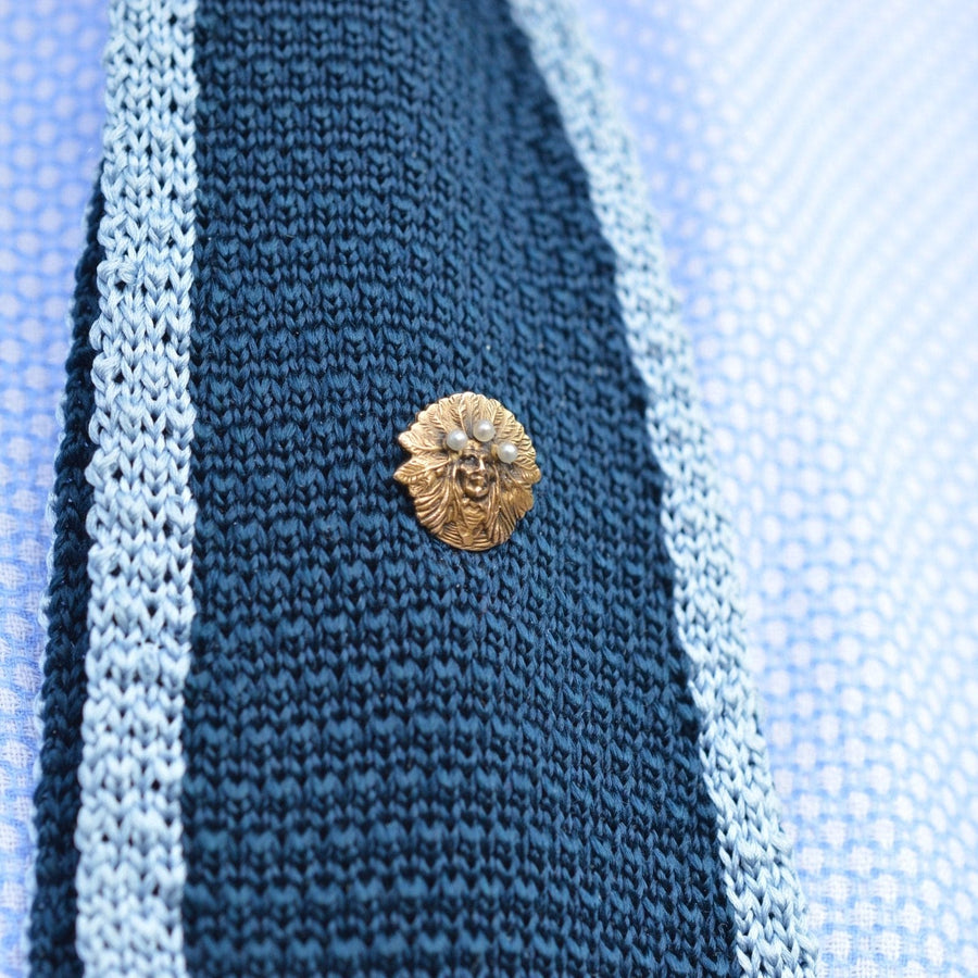 15ct gold Native Indian Chief pin with pearls on a blue knitted tie, perfect accessory for crisp lapels.
