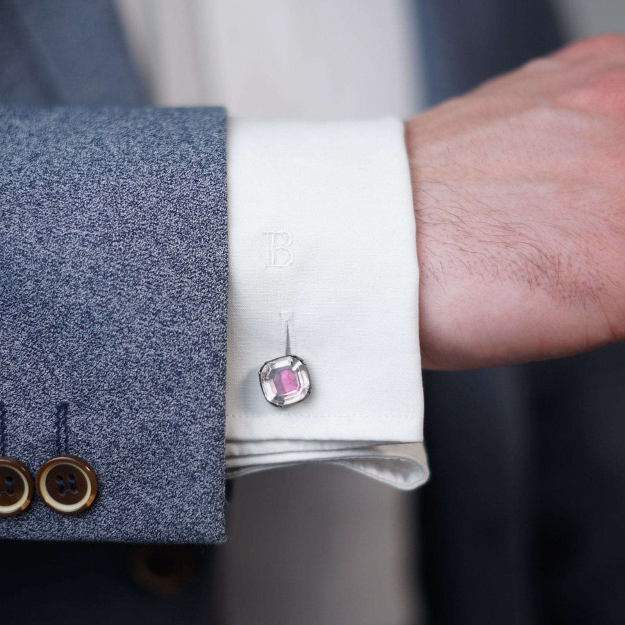 Early Georgian Stuart crystal cufflinks with red-pink foil, paired elegantly on a dress shirt cuff.