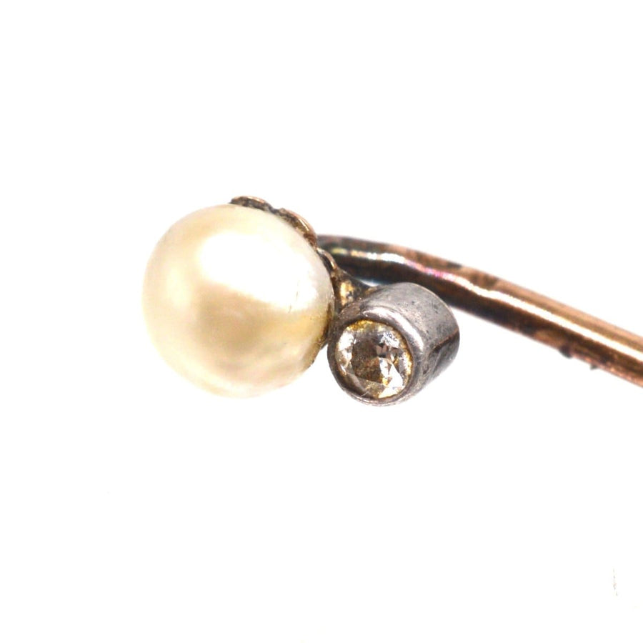 Close-up of an Edwardian 14ct gold tie pin featuring a natural pearl and diamond, showcasing elegant craftsmanship.