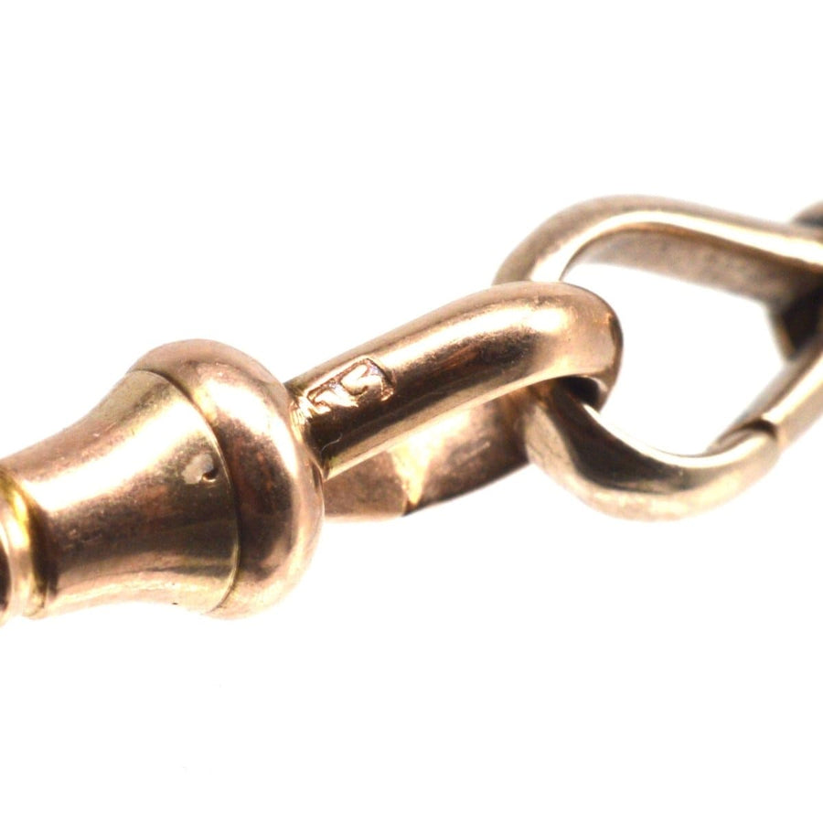 Close-up of an Edwardian 15ct gold Albert chain necklace dog clip, showcasing the intricate design and craftsmanship.