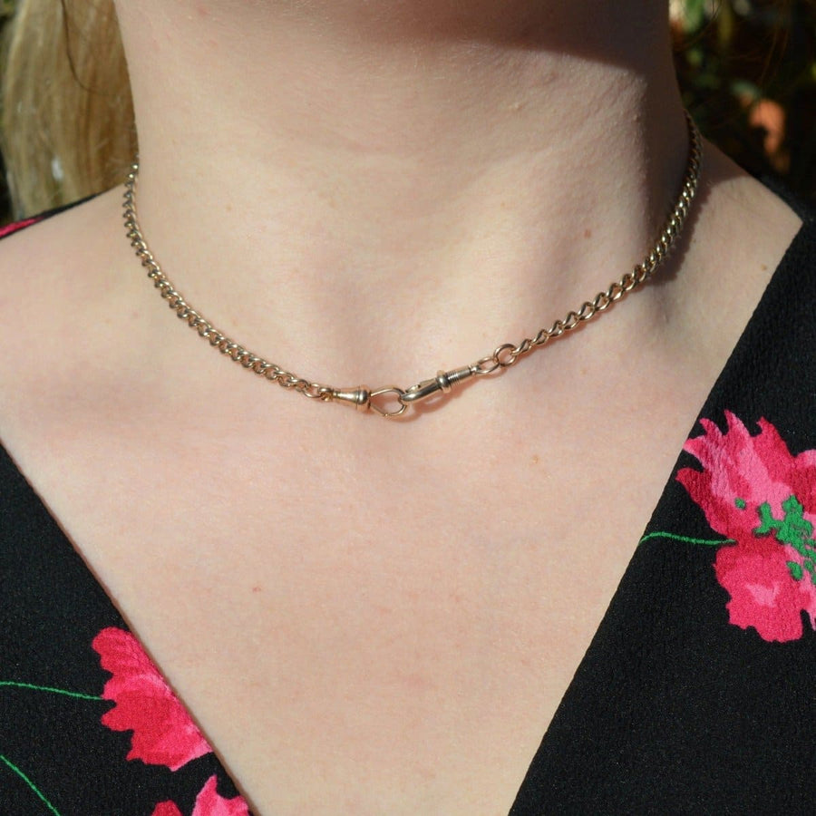 Edwardian 15ct gold Albert chain necklace with dog clips styled as a choker, showcasing intricate details.