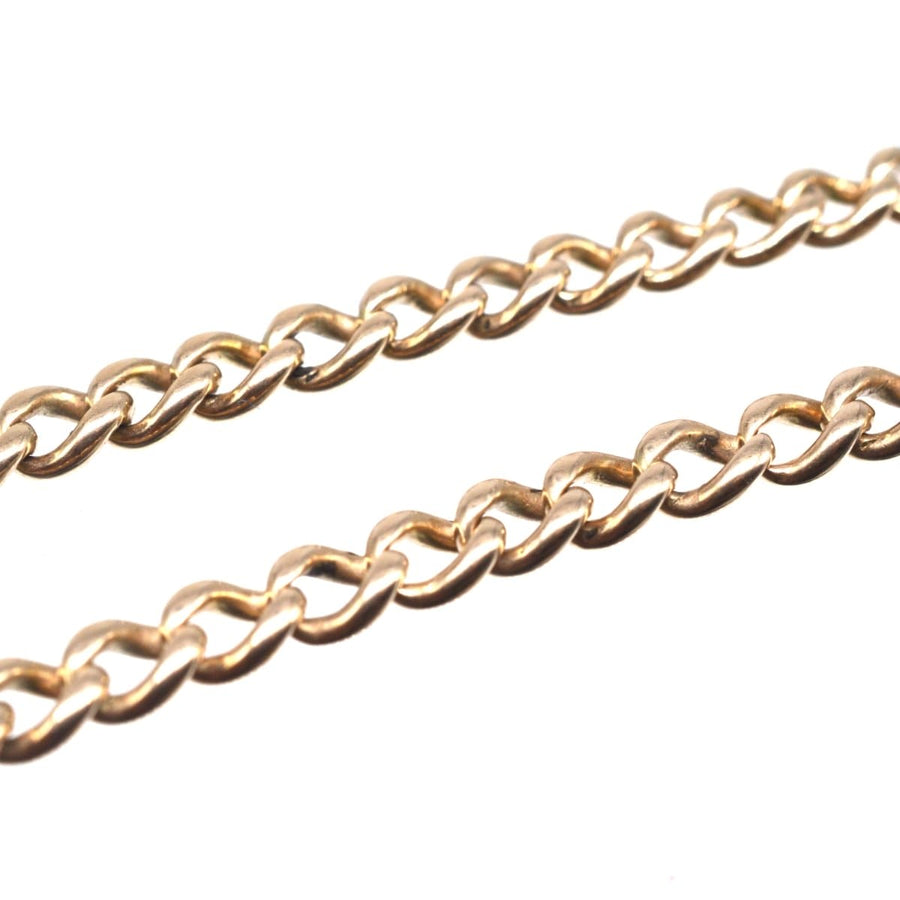 Close-up of an Edwardian 15ct gold Albert chain necklace showcasing intricate links and dog clips.