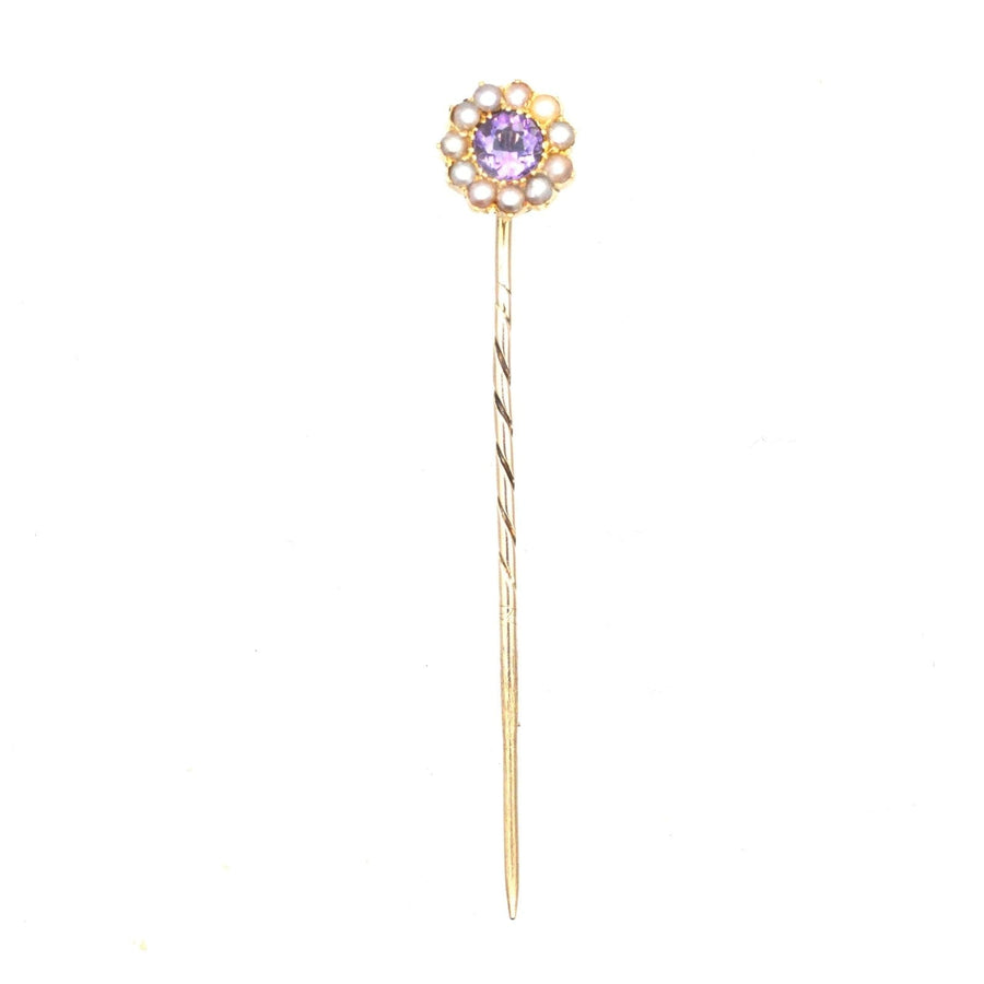 Edwardian 15ct gold stickpin featuring an amethyst center and pearl accents, showcasing fine craftsmanship.