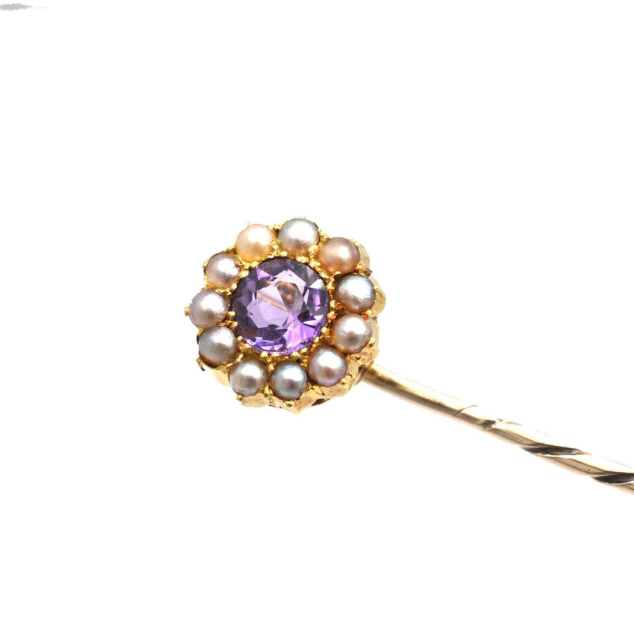 Edwardian 15ct gold stickpin with amethyst center and pearl cluster design.