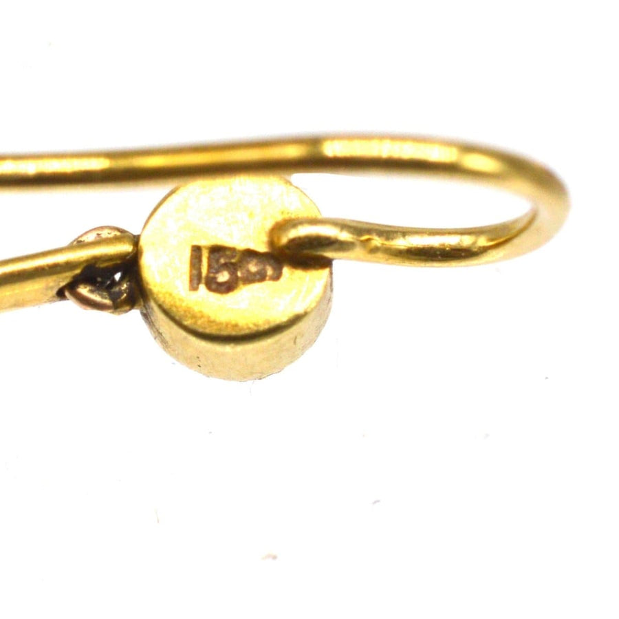 Close-up of 15ct gold hallmark on Edwardian gold drop earrings featuring amethyst and split pearls.