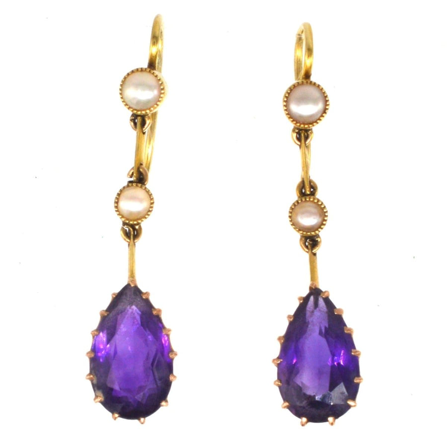 Edwardian 15ct gold drop earrings featuring pear-shaped amethyst and split pearl accents, elegant vintage jewelry.