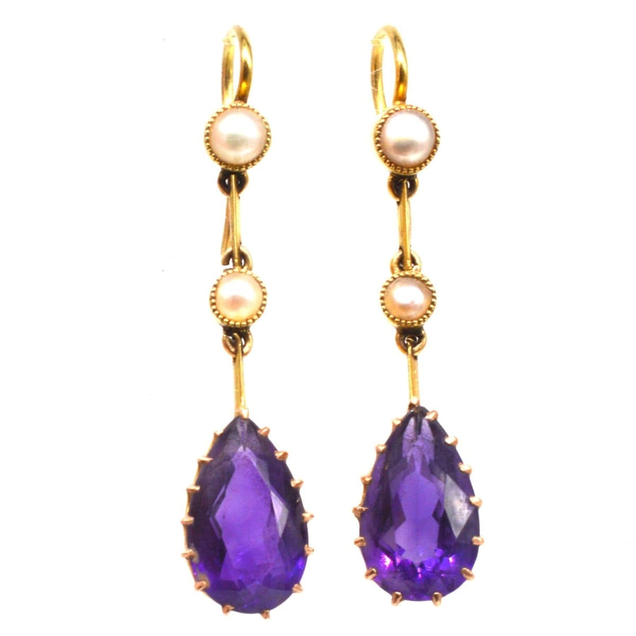 Edwardian 15ct gold drop earrings featuring pear-shaped amethyst and split pearls, showcasing timeless elegance.