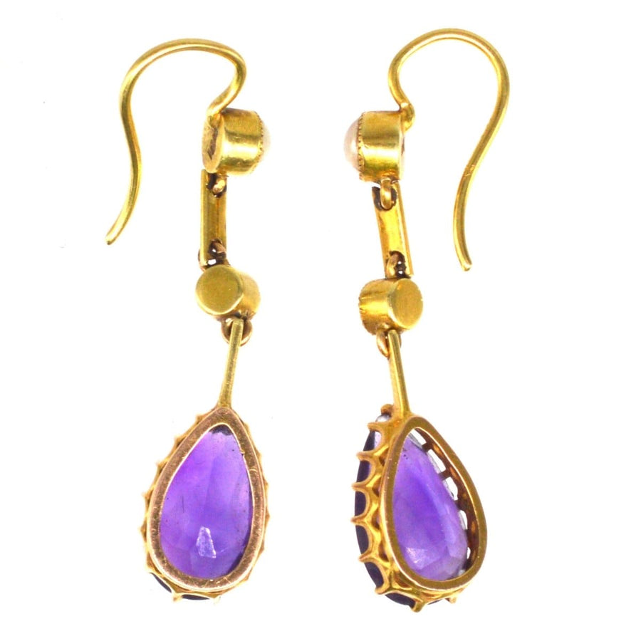Edwardian 15ct gold drop earrings with pear-shaped amethyst and split pearl accents.