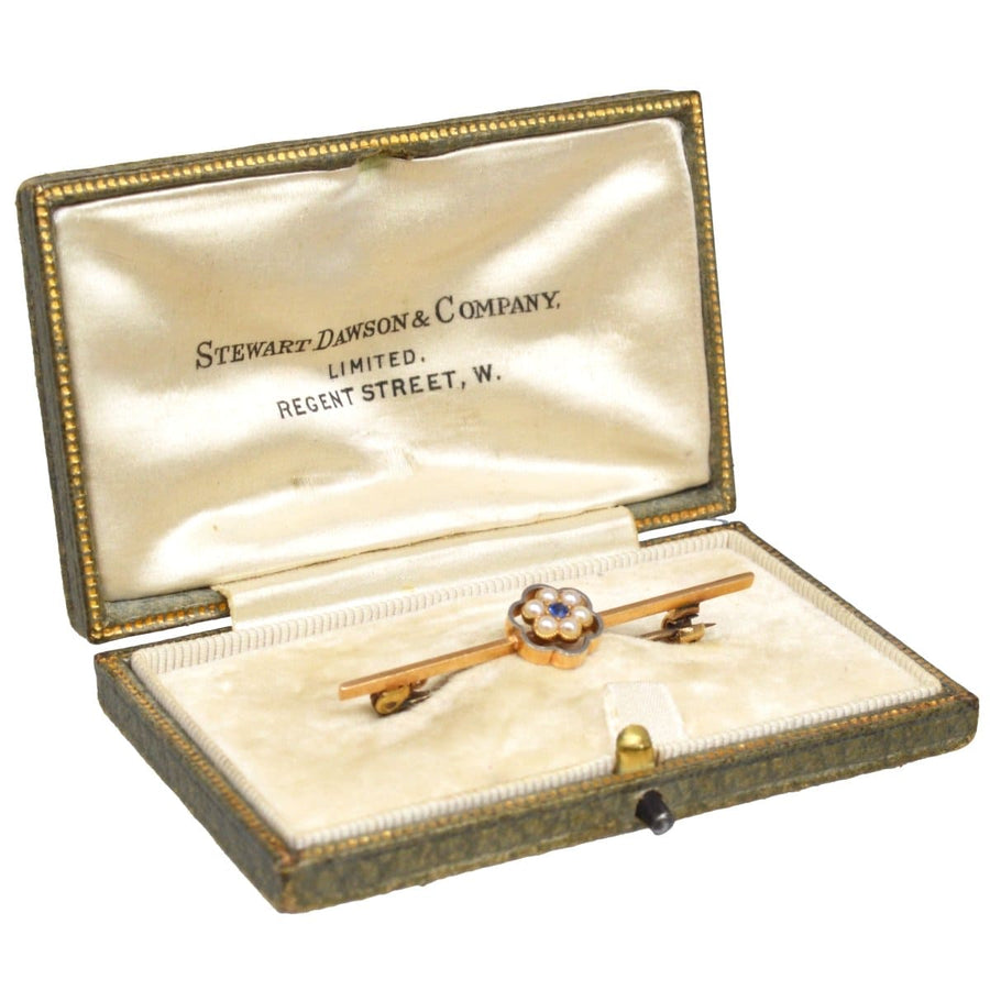 Edwardian bar brooch in box by Stewart Dawson & Company featuring sapphire and pearl flower design in gold and platinum.