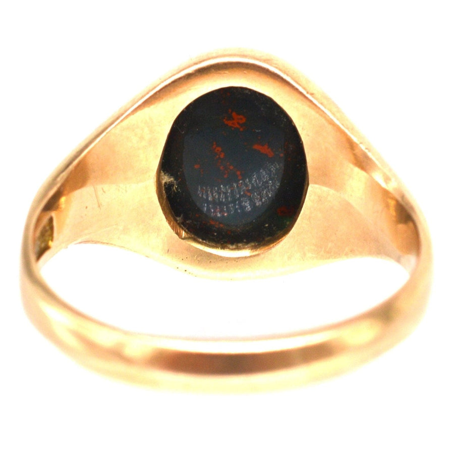 Edwardian 15ct gold bloodstone signet ring with engraved surface and elegant design.