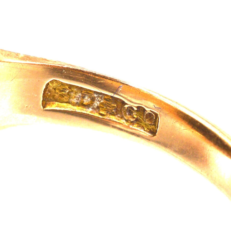 Close-up view of the hallmark inside an Edwardian 15ct gold bloodstone signet ring, showcasing quality craftsmanship.
