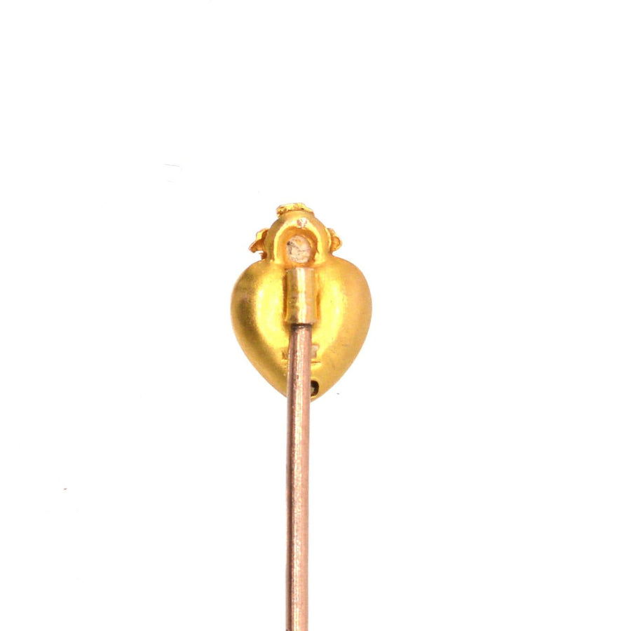 Edwardian 15ct gold burning heart tie pin featuring a lustrous pearl, symbolizing love and desire.