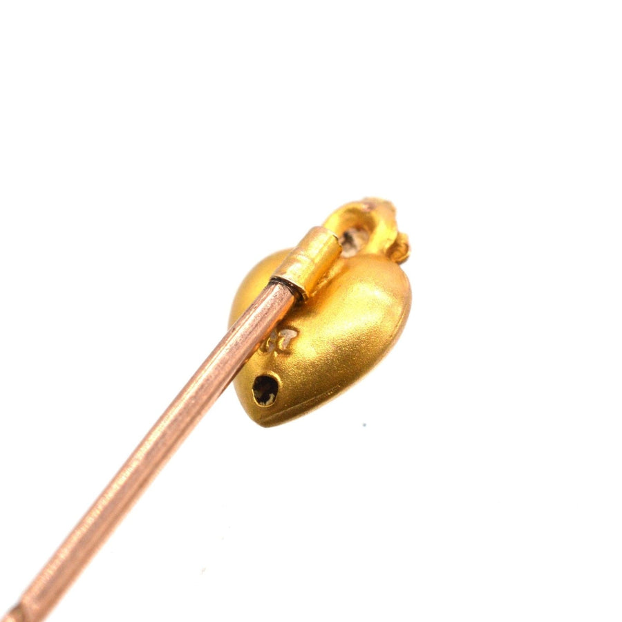 Edwardian 15ct gold burning heart tie pin with lustrous pearl, dating from around 1900, symbolizing love.