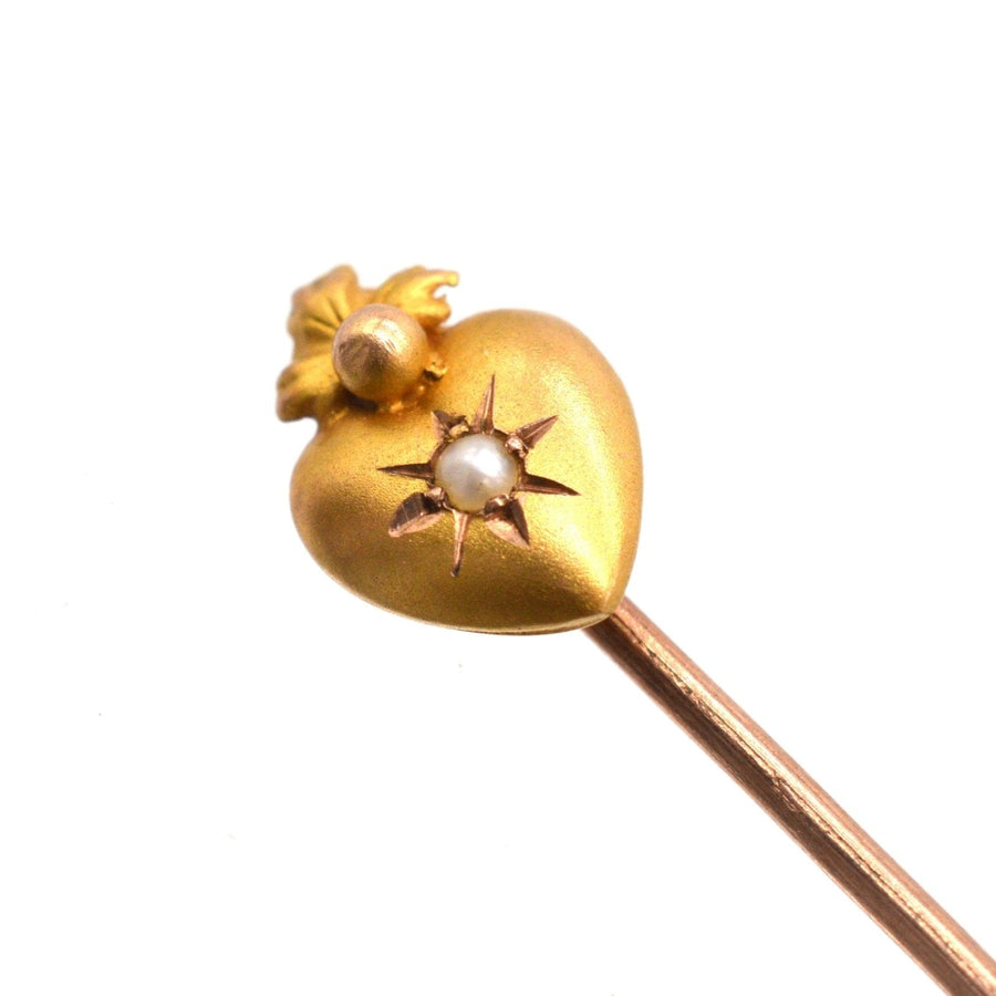 Edwardian 15ct gold burning heart tie pin featuring a lustrous pearl, symbolizing passion and love.
