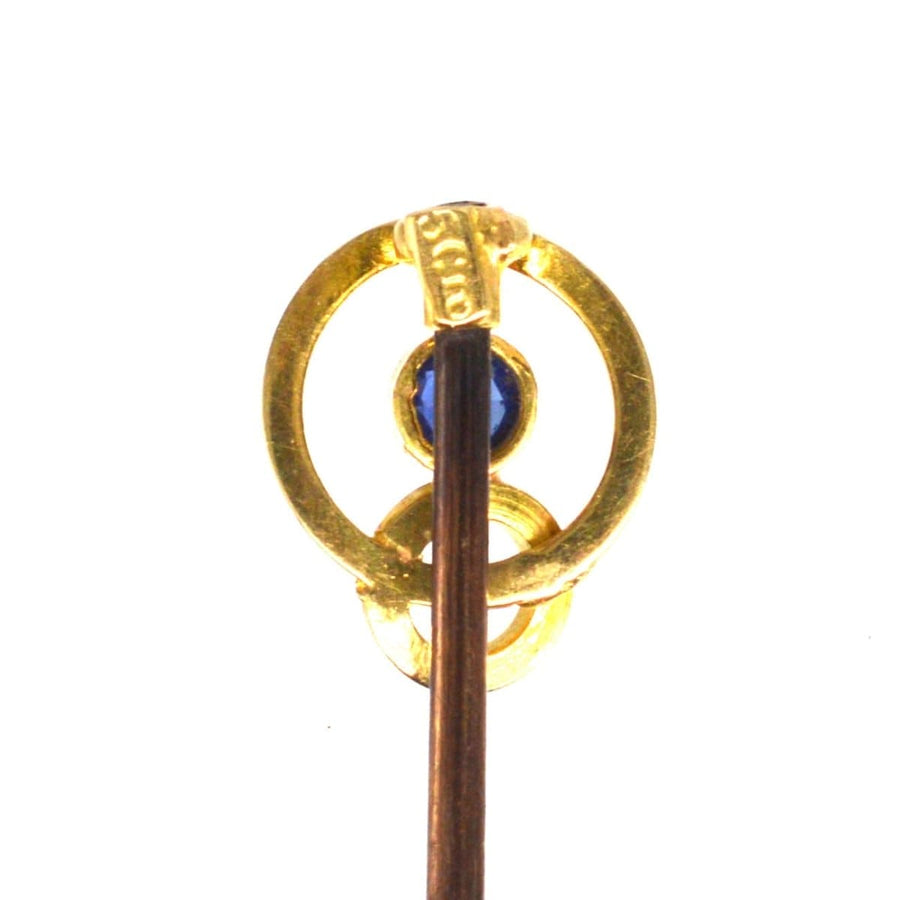 Edwardian 15ct gold double circle tie pin featuring a blue sapphire, crafted circa 1900-1910.