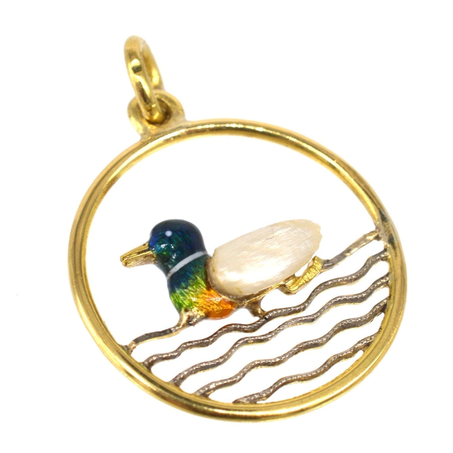 Edwardian 15ct gold duck pendant featuring baroque pearl and enamel, framed in a circular design.
