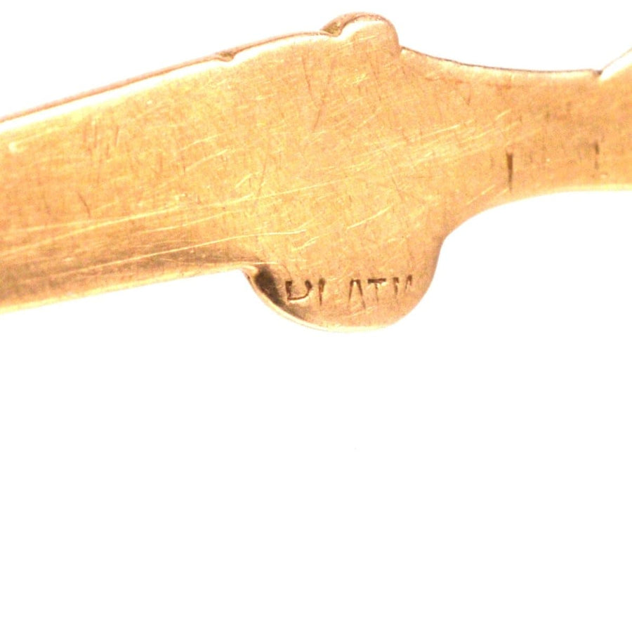 Close-up of the hallmark engraving on a vintage 15ct gold and platinum grouse and shotgun brooch.