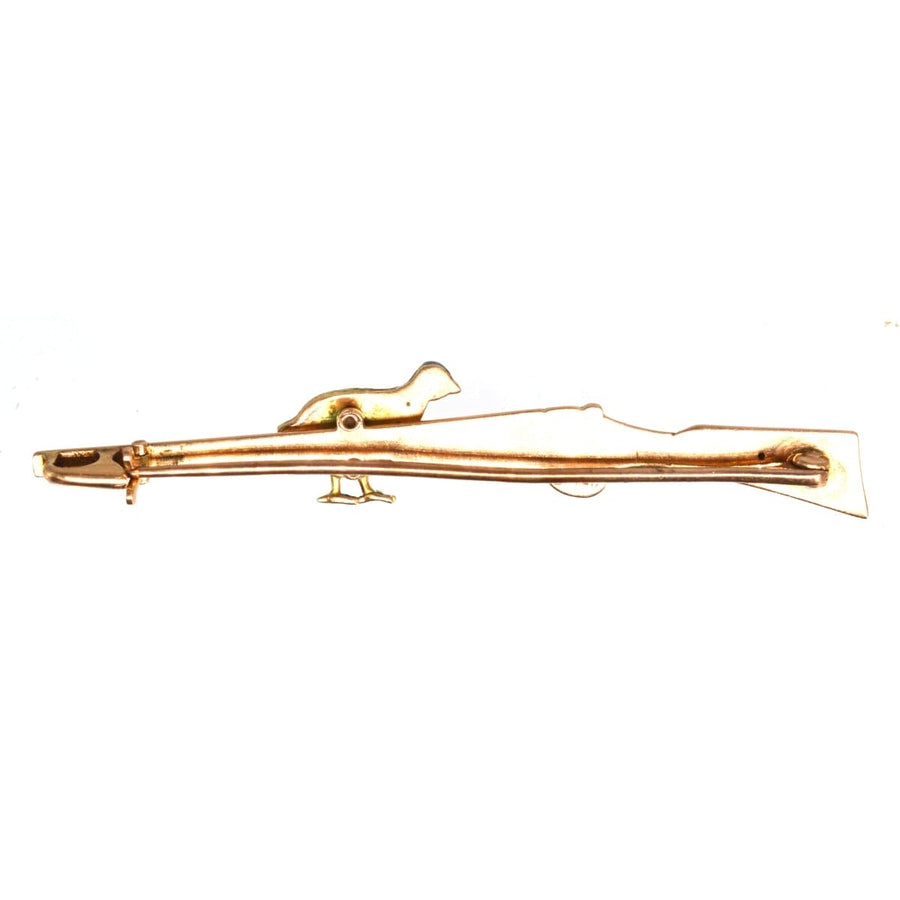Edwardian brooch featuring a grouse and shotgun in gold and platinum, showcasing vintage craftsmanship.