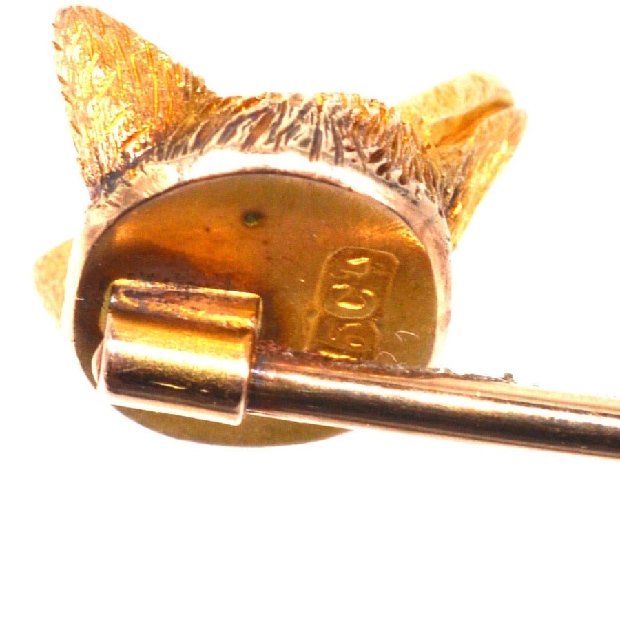 Back view of an Edwardian 15ct gold fox tie pin with red garnet eyes and securing pin.