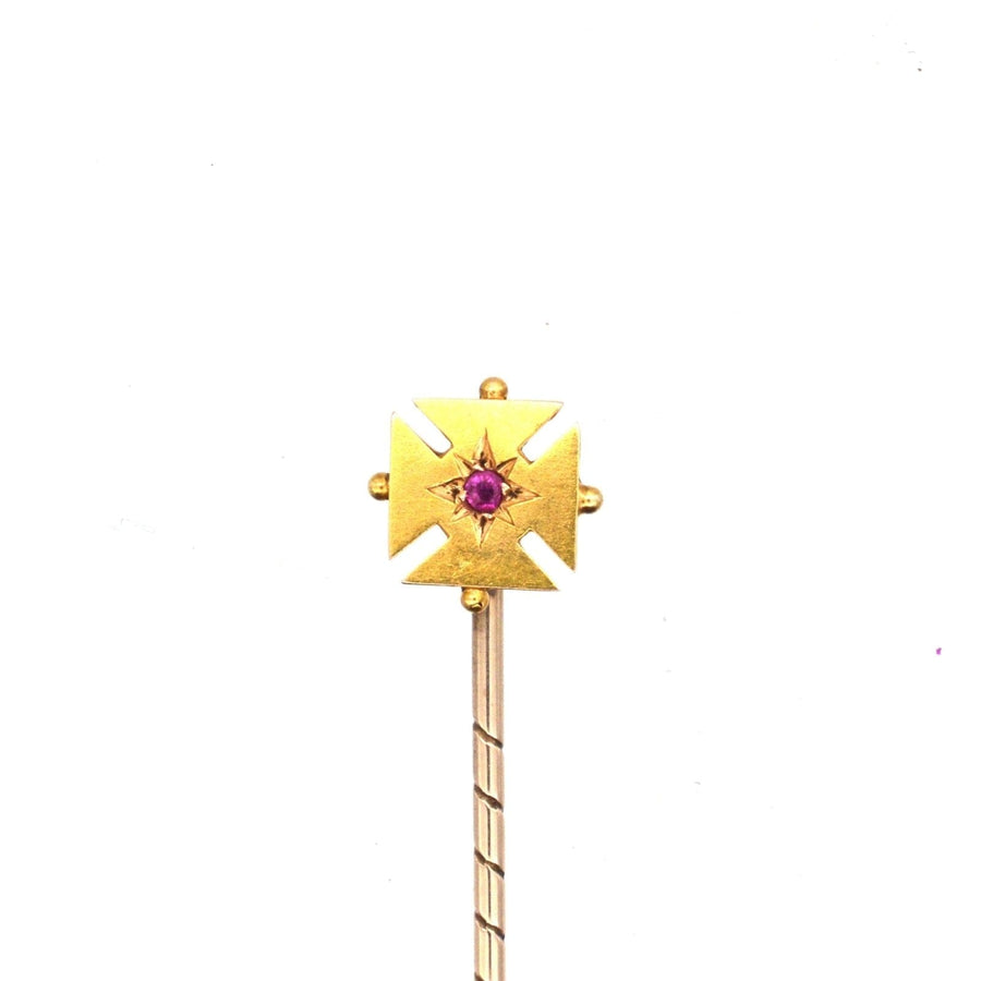 Edwardian 15ct gold Maltese cross tie pin featuring a central ruby gemstone, ideal for colorful silk ties.