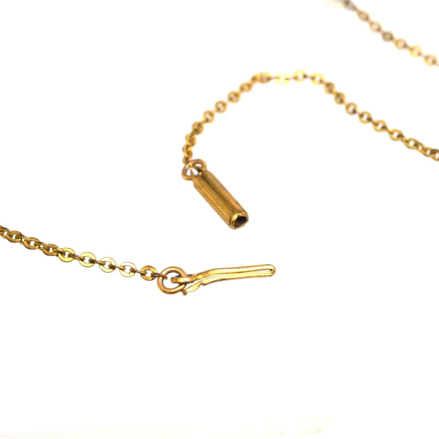 Close-up of a gold chain necklace featuring a clasp detail, showcasing fine craftsmanship and elegance.