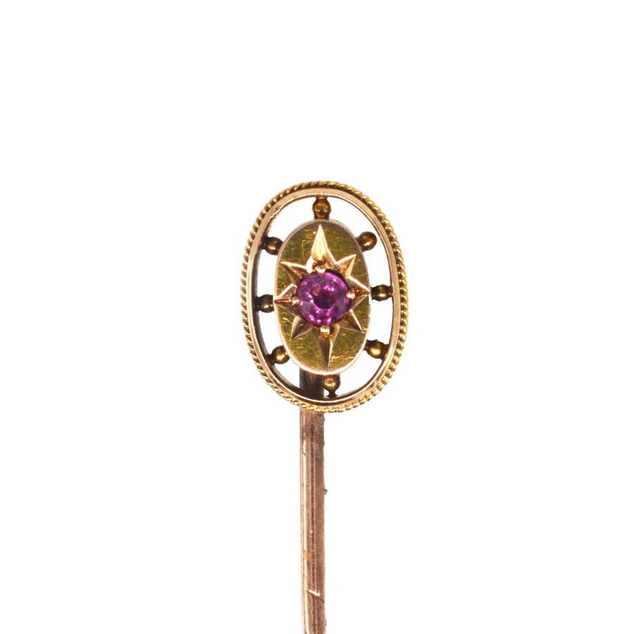 Edwardian 15ct gold oval ruby star tie pin with gold stone balls, ideal for silk ties and lapels.