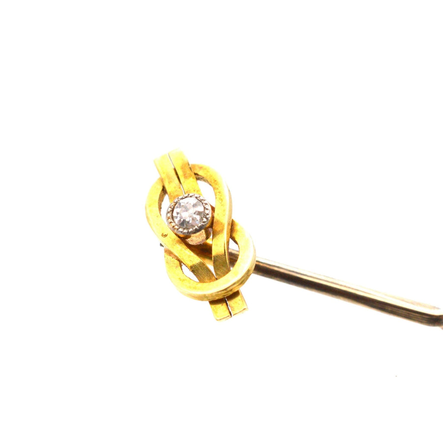 Edwardian 15ct gold reef knot tie pin with diamond, symbolizing love and friendship.