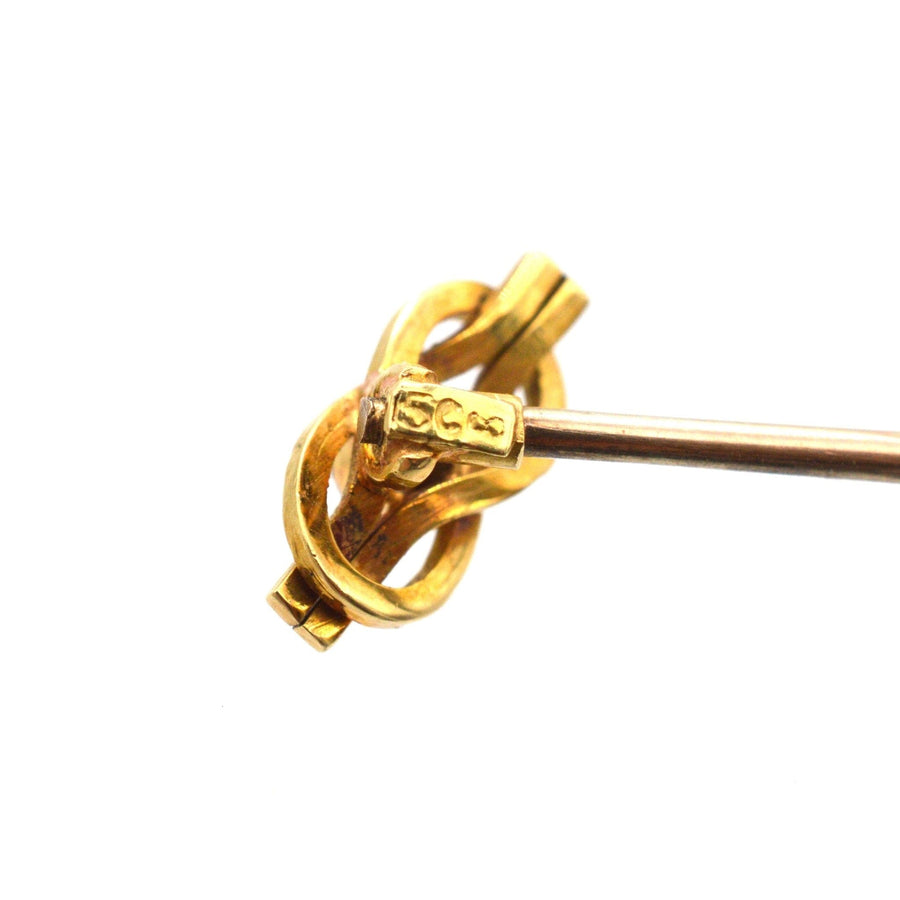 15ct gold reef knot tie pin with diamond, symbolizing love, crafted circa 1900, featuring intricate design and hallmark.