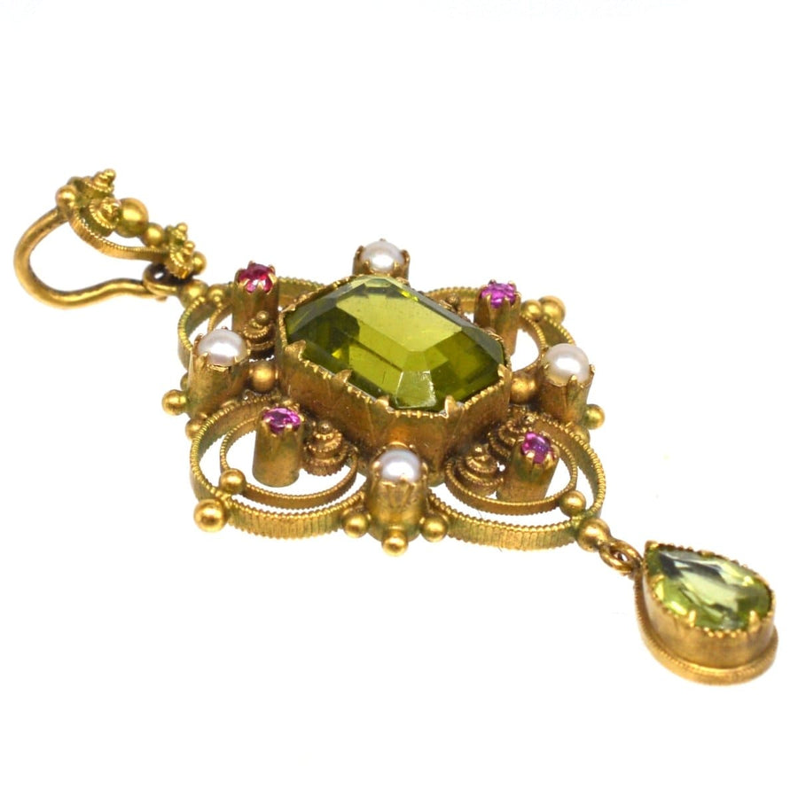 15ct gold Suffragette pendant showcasing peridot, pearls, and rubies, reflecting craftsmanship and support for women's rights.