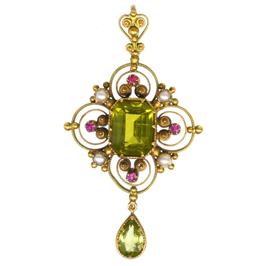 Edwardian 15ct gold Suffragette pendant with peridot, pearls, and rubies showcasing suffragette colors and exquisite craftsmanship.