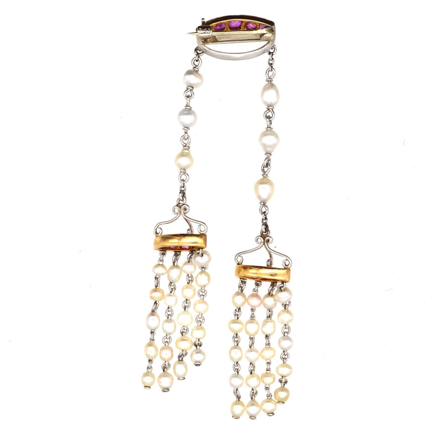 Edwardian brooch featuring Burma rubies, natural pearls, and rose diamonds in gold and platinum setting.