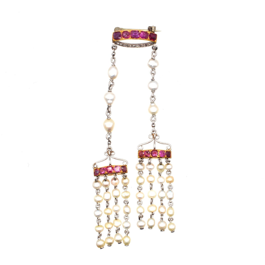 Edwardian brooch featuring Burma rubies, natural pearls, and rose diamonds in gold and platinum.