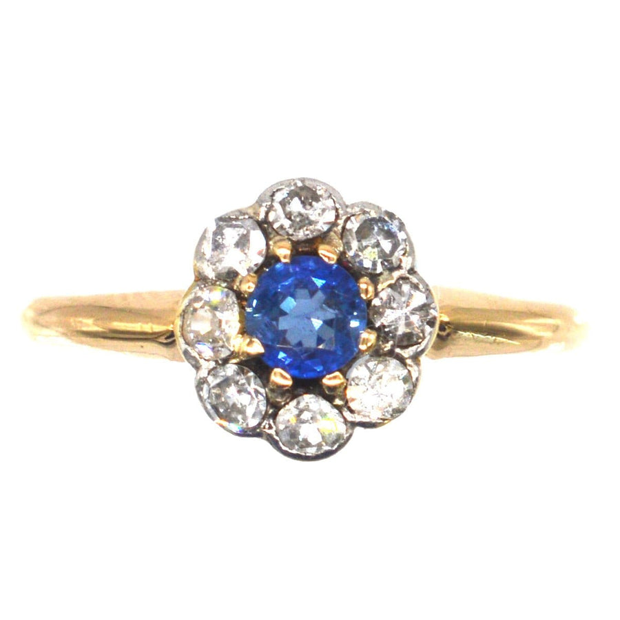 Edwardian 18ct gold and platinum sapphire and diamond cluster ring, showcasing a stunning Ceylon blue sapphire.