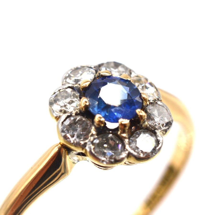 Edwardian 18ct gold and platinum cluster ring featuring a cornflower blue Ceylon sapphire and sparkling diamonds.