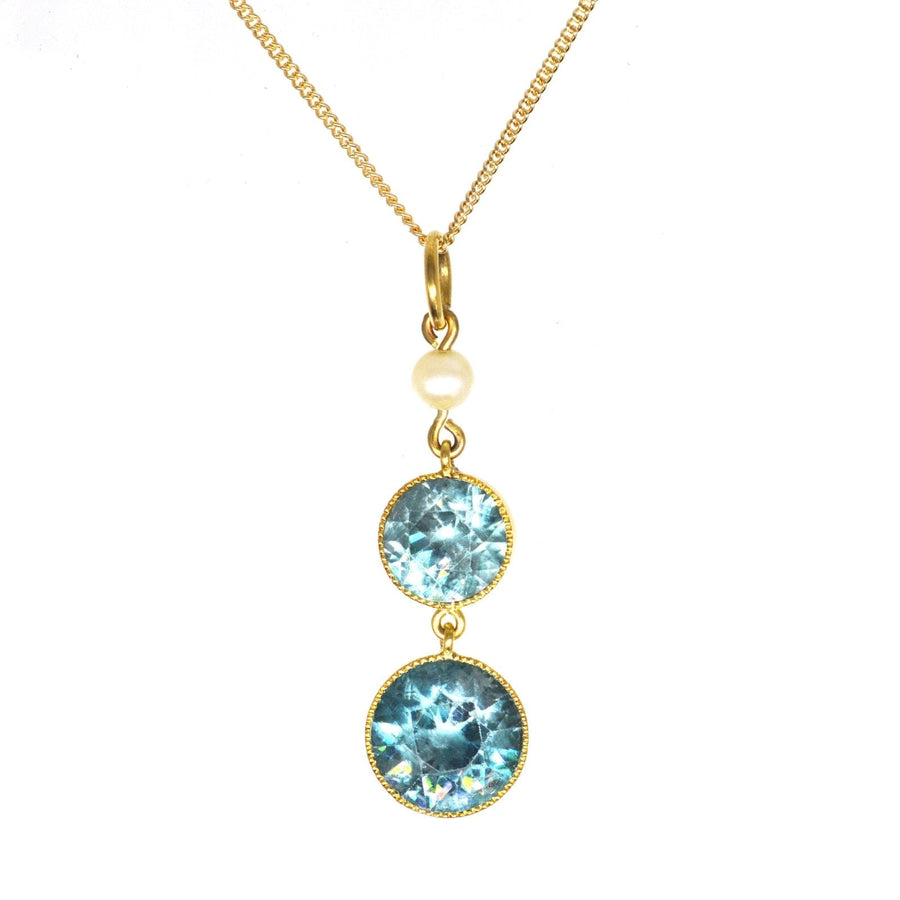 Edwardian 18ct gold pendant featuring two blue zircons and a pearl on a 9ct gold chain.