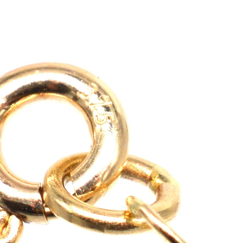 Close-up of 9ct gold curb link chain showing detailed links and hallmark.